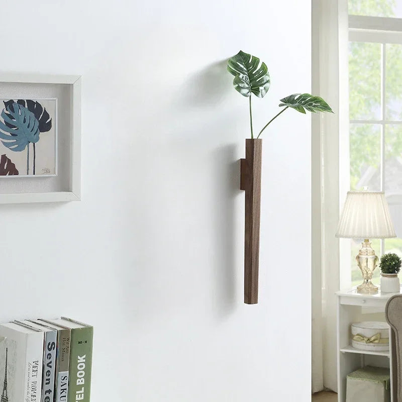Dark wood wall hanging plant holder with two green monstera leaves for bohemian home decoration