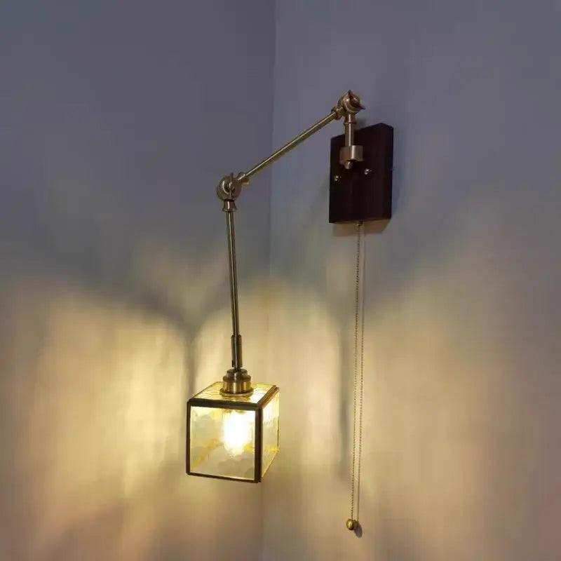 Brass-finished adjustable wall sconce with square cube glass led shade and dark walnut decorbites cube glass mounting plate