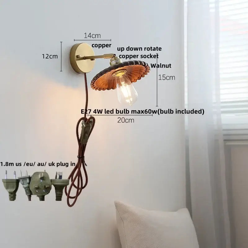 Walnut and brass wall sconce with pull chain switch featuring copper scalloped shade and exposed edison bulb for bedroom light
