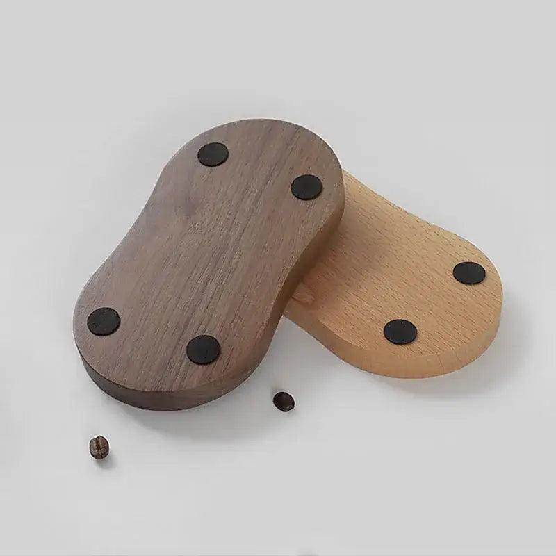 Two wooden tamping station coasters in dark walnut and light oak with black adhesive pads for decorbites espresso tamper base