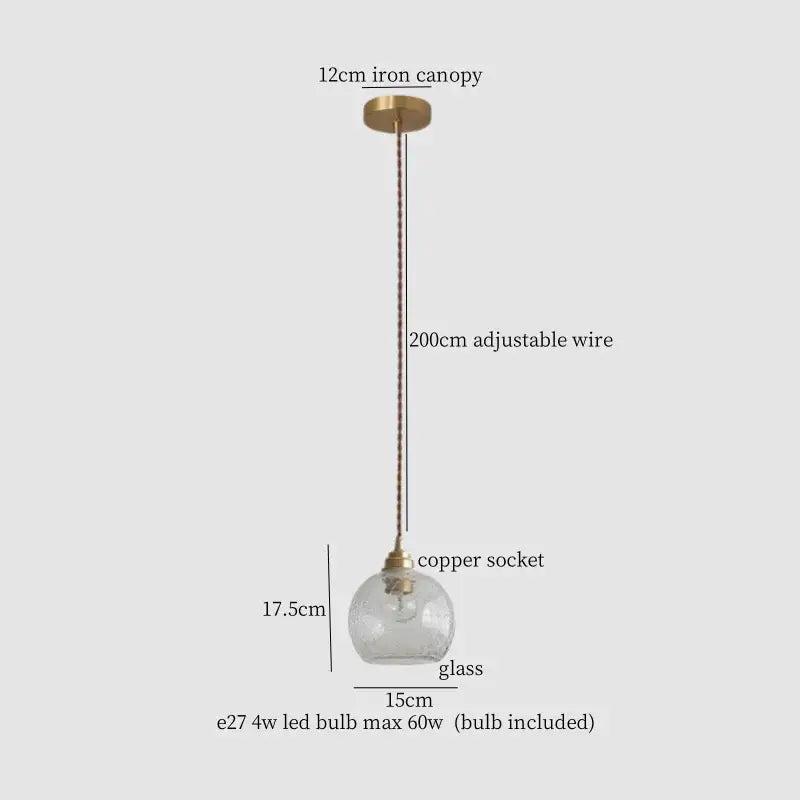 A clear glass globe pendant light with warm brass cracked glass led socket and iron canopy for kitchen dining room decorbites