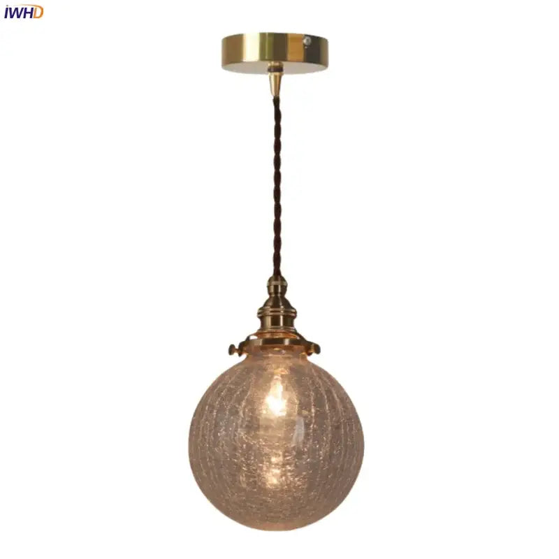 Warm brass cracked glass led pendant light with textured glass globe and twisted cord for kitchen dining room decorbites