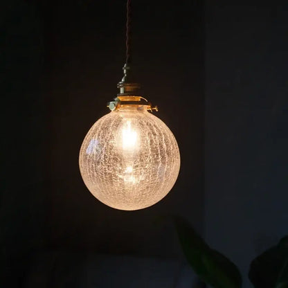 Warm brass cracked glass led pendant light with crackled texture and brass hardware for kitchen dining room decorbites