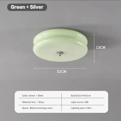 A sleek round ceiling light with translucent green double layer glass led shade and silver iron fixture for bedroom