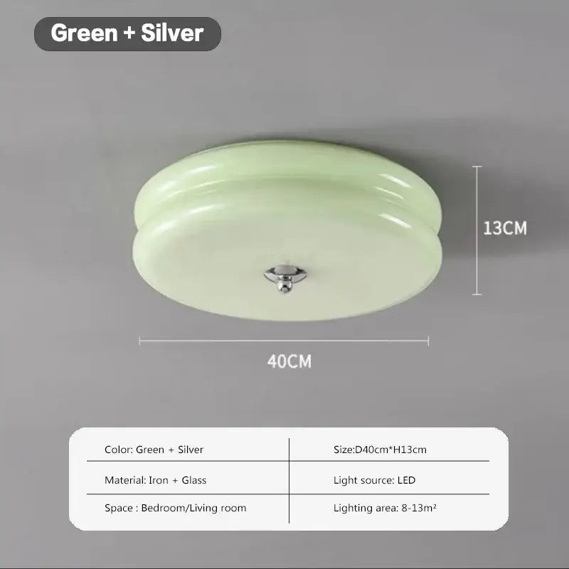 A sleek round warm chrome double layer glass led ceiling light with translucent green glass dome and silver frame for bedroom