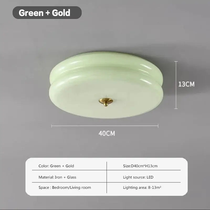 A sleek warm chrome ceiling light with pale green double layer glass led diffuser and gold-toned iron fixture