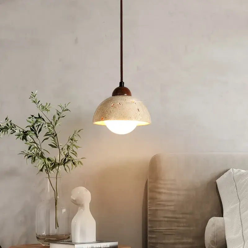 Warm textured concrete cave stone pendant light with dark metal stem ideal for dining room decorbites cave stone pendant