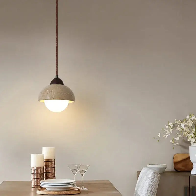 Warm textured concrete cave stone pendant light with matte finish and dark metal hardware for dining room decorbites cave stone pendant