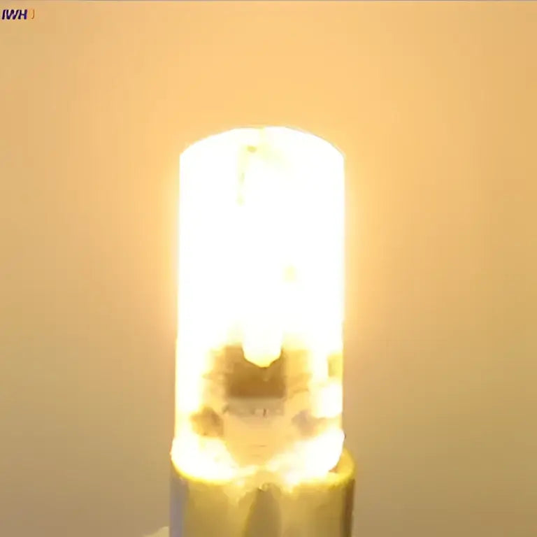 A warm white decorbites dimmable led bulb with cylindrical glass body and metallic base for living room lighting