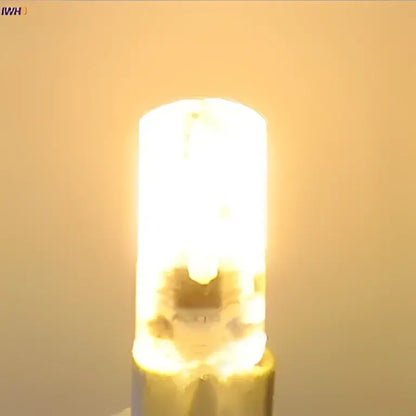 A warm white dimmable decorbites led bulb with a cylindrical glass body and metallic base for living room lighting