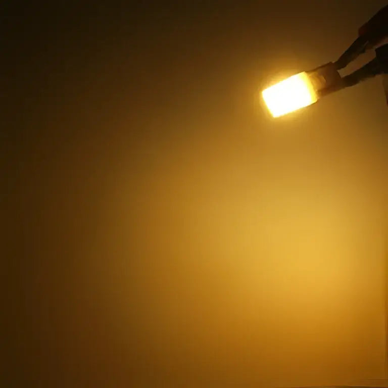 A warm white decorbites g9 led bulb 1w cob with amber rectangular led light and metallic base for bedroom lighting