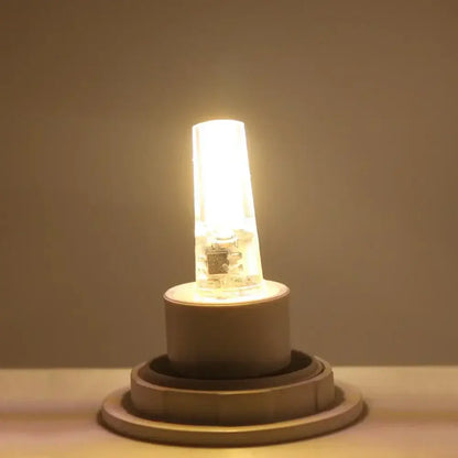 Warm yellow glass decorbites g4 cob led bulb with clear casing and visible internal circuitry for living room crystal light