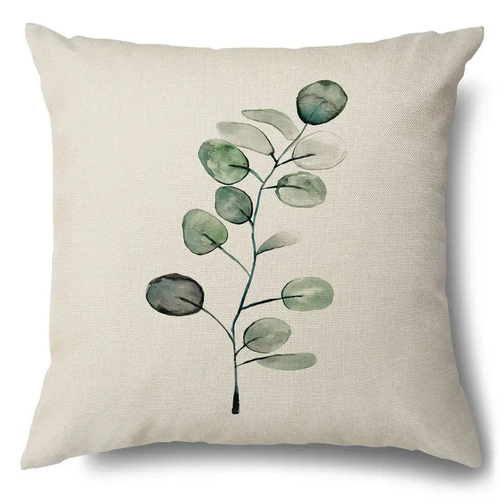 Beige linen pillow case with watercolor green leaves decorative eucalyptus branch design for living room use