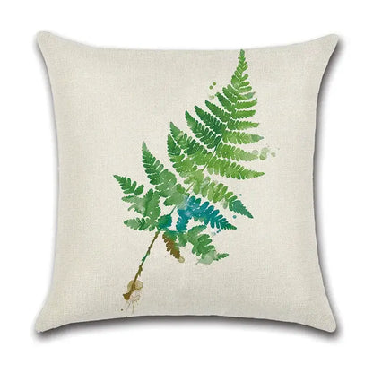 Beige linen pillow case with watercolor green leaves decorative design in shades of green and teal for living room use