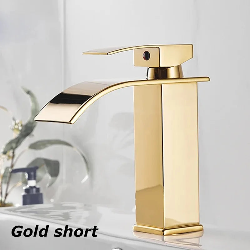 Gold short faucet with polished metallic finish for stainless steel wash basin in modern bathroom settings
