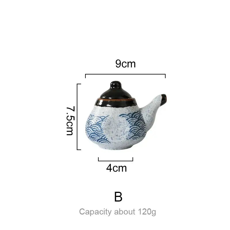 A small ceramic teapot with blue wave patterns and black lid from the decorbites blue ceramics seasoning set