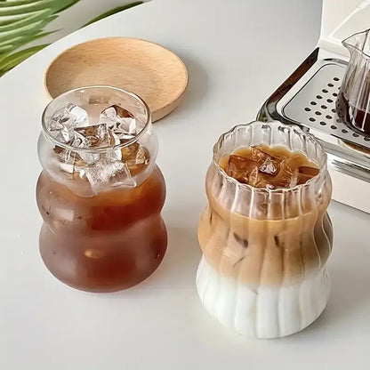 Two clear wavy ribbed glass cups 500ml ins glass tumblers filled with iced coffee and ice cubes