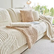 Cream-colored plush sofa cover with wavy ribbed texture and matching throw blanket for living room set