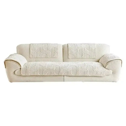 Cream-colored quilted sofa cover with soft textured fabric and flowing wave pattern for living room use