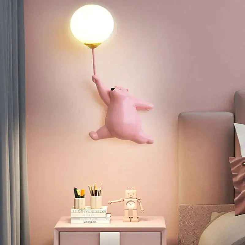 Pink bear wall lamp with a white spherical light fixture designed for a whimsical kids bedroom decor