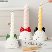 Three whimsical ceramic bowknot tree candle holders with textured white bases and colorful twisted candles for decorbites decor