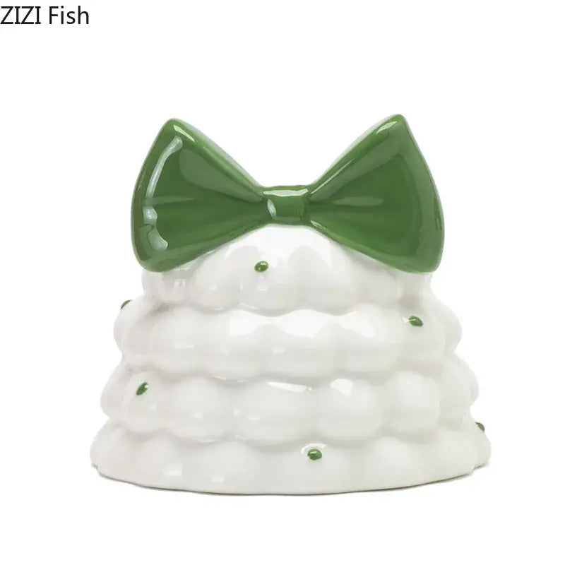 Whimsical white ceramic candle holder shaped like a bowknot tree with a glossy green bow and decorative green dots decorbites bowknot tree