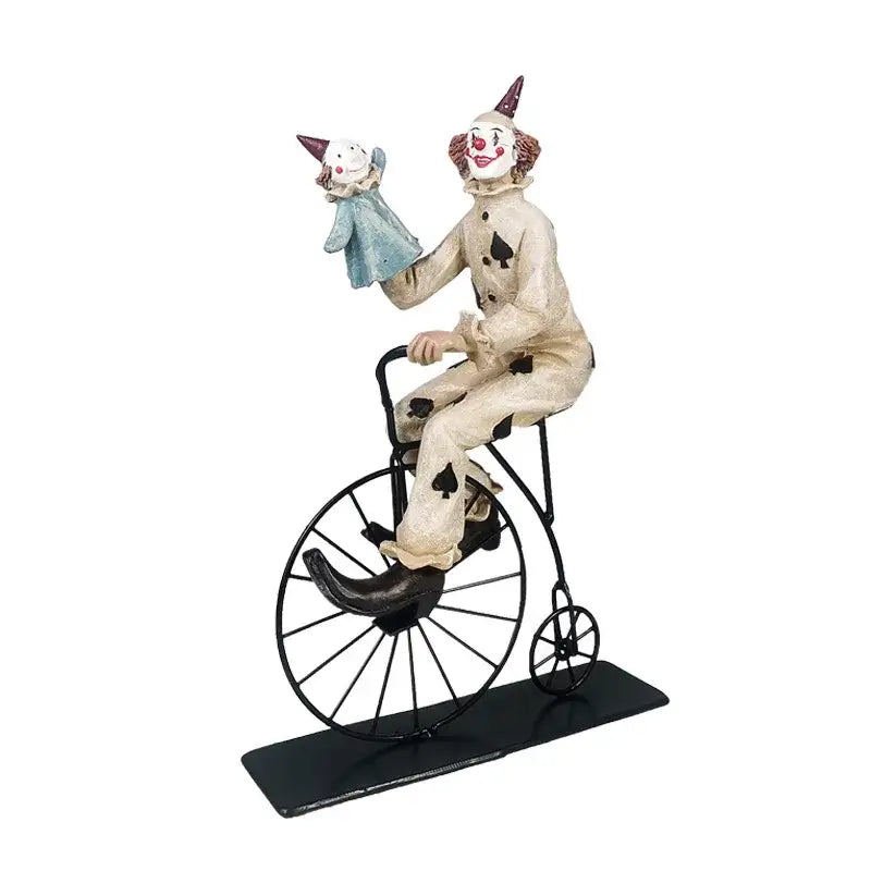 Whimsical cream circus clown joker figurine in black spade suit riding vintage bicycle with small doll for living room decor