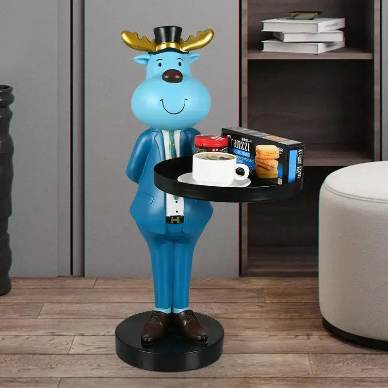 Blue moose figurine tray ornament wearing gold antler top hat and suit holding a black tray with coffee and snacks