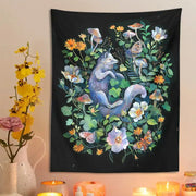 Black tapestry featuring a whimsical blue-gray fox in a vibrant floral garden tapestry for decorbites botanical floral decor