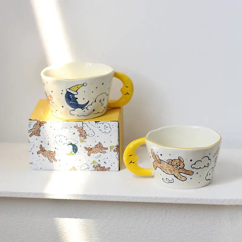 Cute off-white bear moon ceramic mugs with yellow handles featuring whimsical teddy bear moon cloud and star illustrations