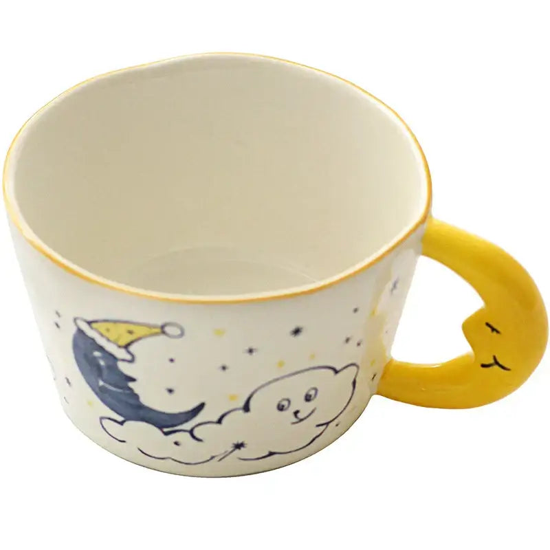 Off-white bear moon ceramic mug with a yellow crescent moon handle and sleeping crescent moon illustration