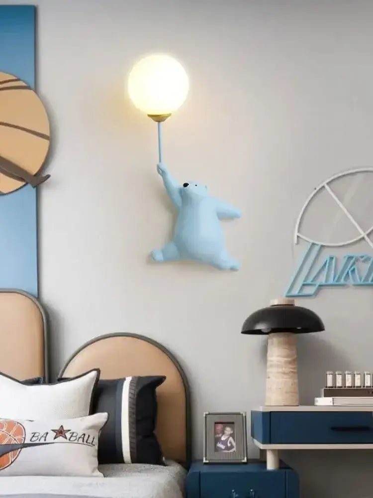 Light blue polar bear kids wall lamp with spherical bulb and gold-toned base from whimsical wall lamp set for bedroom