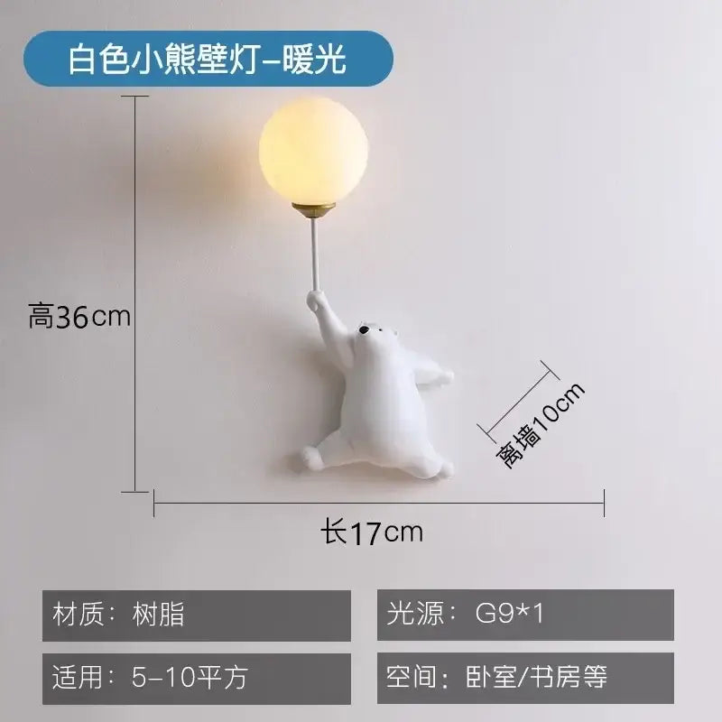 White polar bear kids wall lamp with warm glowing spherical bulb held aloft in whimsical pink blue and white wall lamp set