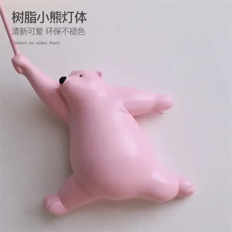 Whimsical pink resin bear kids wall lamp set with glossy finish and black nose designed for bedroom wall mounting