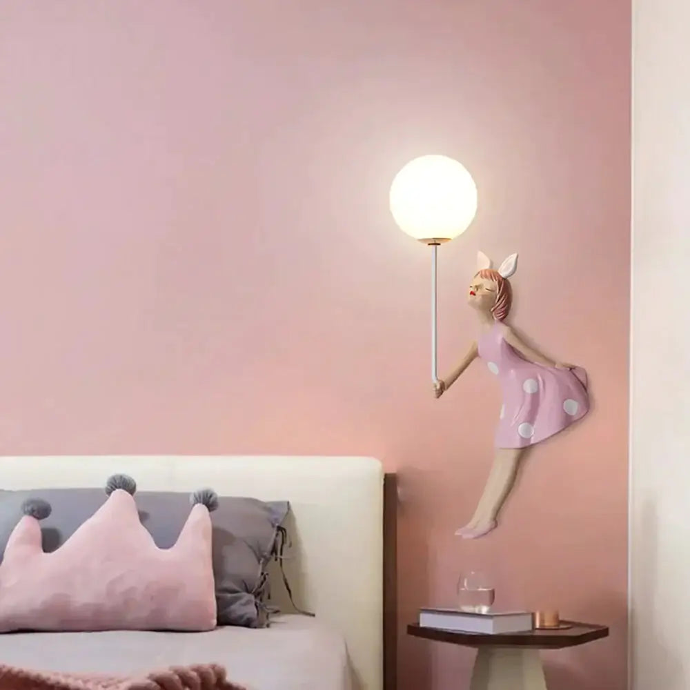 Whimsical pink polka dot fairy girl wall lamp with bunny ears and glowing spherical light for bedroom wall lamp