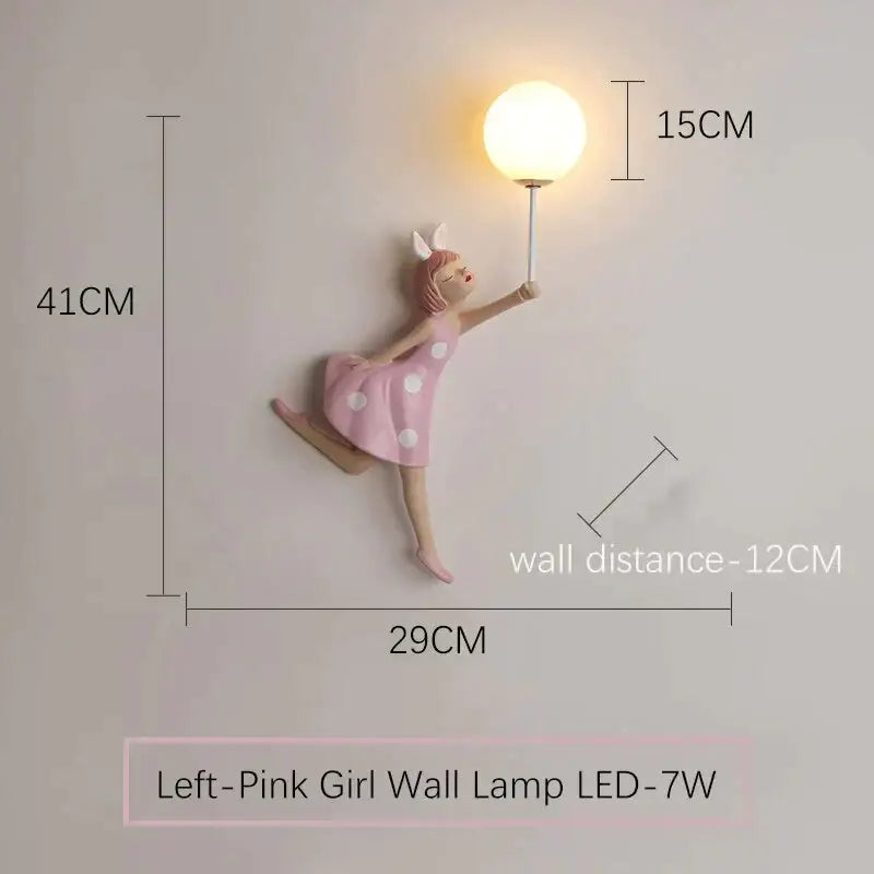 Whimsical pink girl wall lamp shaped like a fairy girl in a polka dot dress with bunny ears holding an illuminated bulb