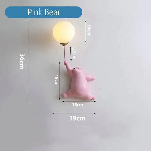Whimsical pink polka dot girl wall lamp featuring a bear holding a warm-toned round bulb for bedroom lighting