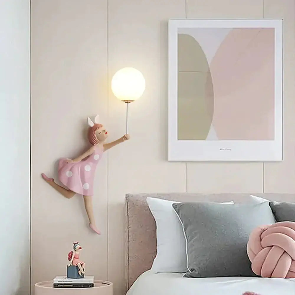 Whimsical pink polka dot girl wall lamp figurine with white bunny ears holding a spherical wall lamp for bedroom