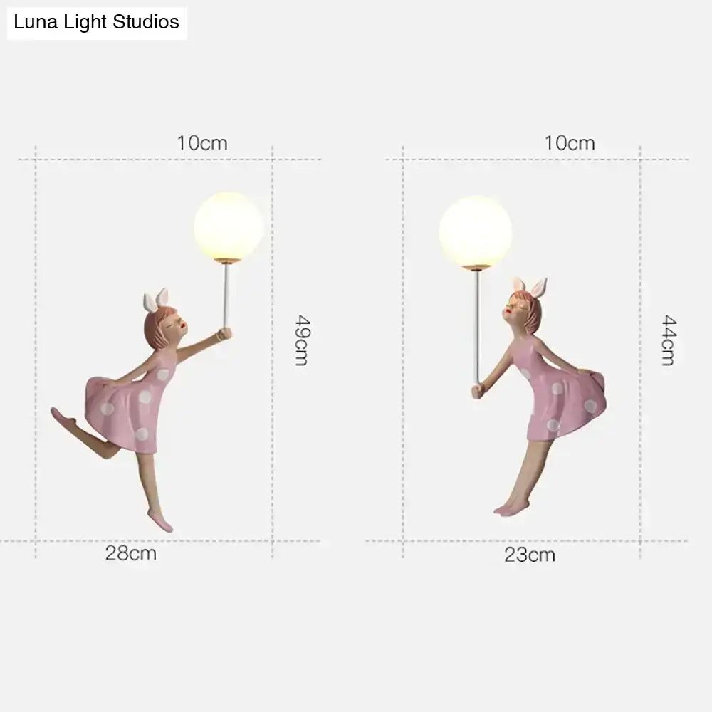 Whimsical pink polka dot fairy girl wall lamp holding a spherical lamp ideal for bedroom girl wall lamp decor