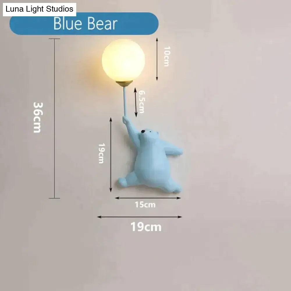 A light blue sculpted polar bear wall lamp with a warm bulb held by its paw for a whimsical girl wall lamp decor
