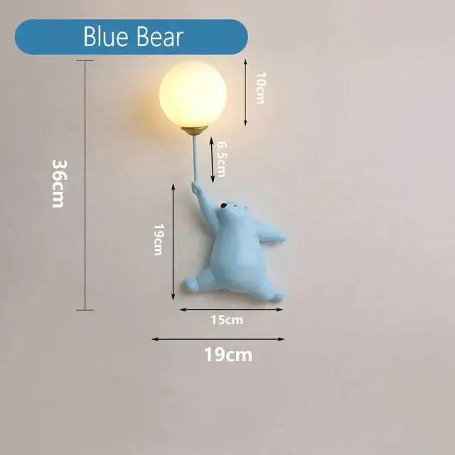 Light blue resin polar bear wall lamp holding a spherical bulb complements whimsical pink polka dot girl wall lamp