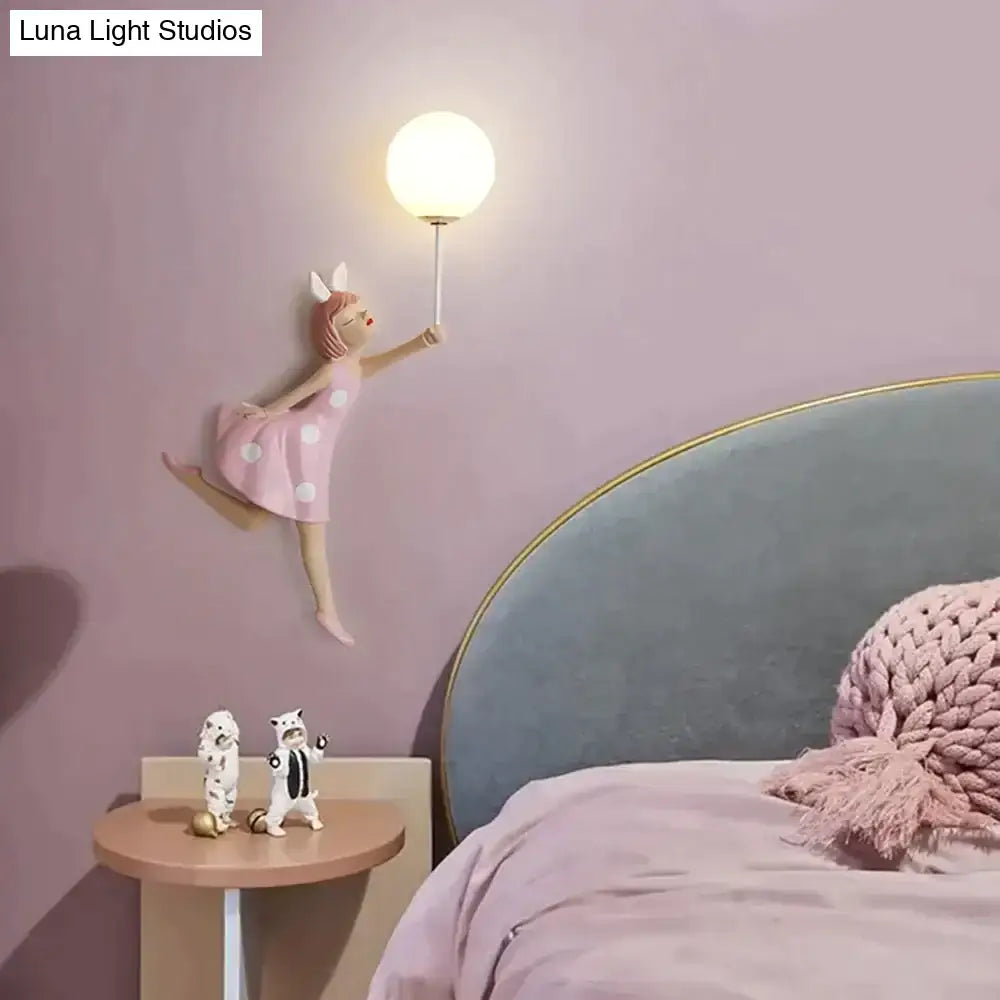 Whimsical pink polka dot fairy girl wall lamp with spherical white lampshade for bedroom lighting