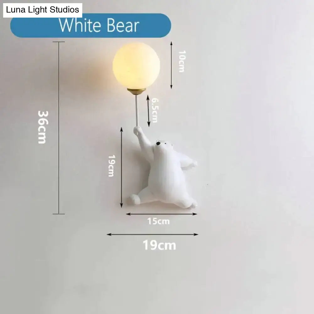 White polar bear girl wall lamp with spherical frosted glass bulb featured in whimsical pink polka dot bedroom design