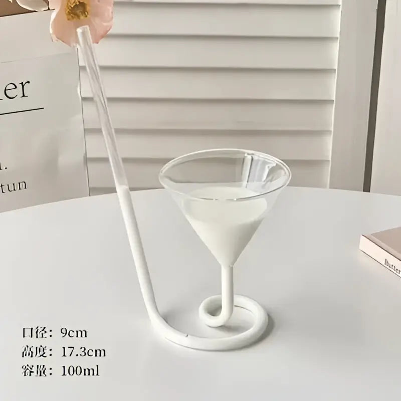 Whimsical pink vampire cocktail glass cup with a white glass cup straw and spiral base for dining room decor
