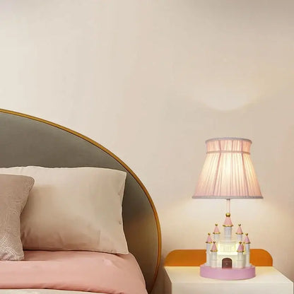 Delicate pink and white castle kids chandelier led table lamp with gold accents and pleated fabric shade by decorbites castle kids