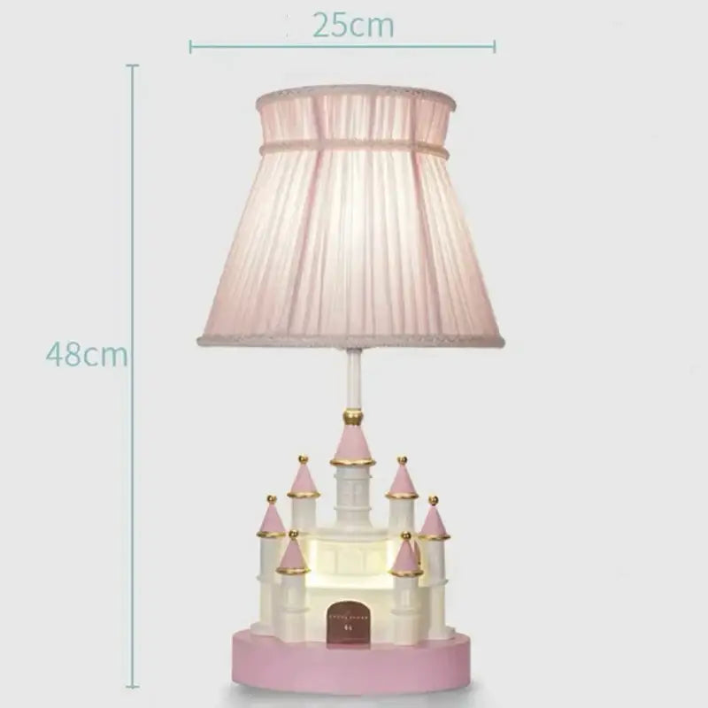A charming pink and white decorbites castle kids chandelier led table lamp with pleated fabric shade for bedrooms