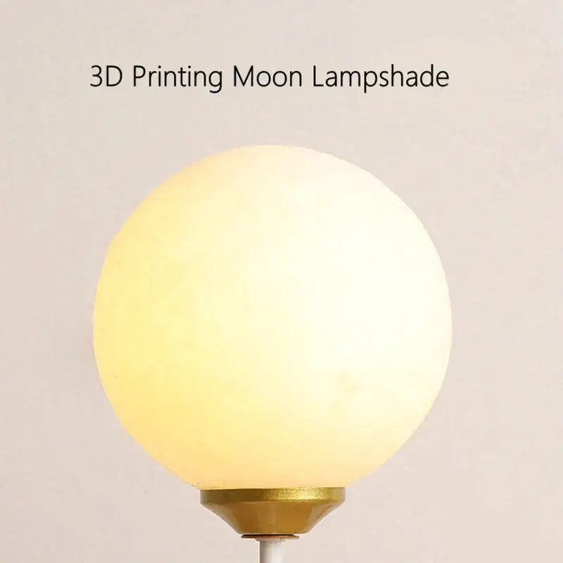 Whimsical polar bear moon table lamp with a smooth matte spherical lampshade and soft yellow glow gold accent light