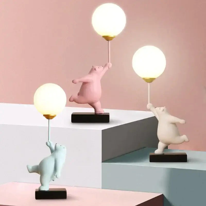 Three whimsical polar bear moon table lamps with glowing spherical lamps and gold-tone bases for bedroom decor