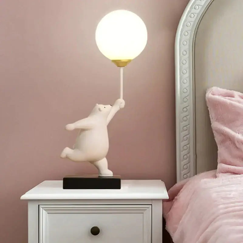White ceramic bear moon lamp with spherical frosted glass globe and gold-toned base table lamp for bedroom accents
