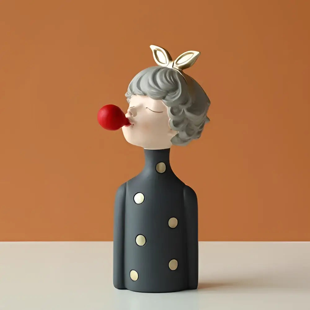 Gray ceramic bubble girl resin figurine with silver bunny ears and white polka dots blowing red bubblegum for decor